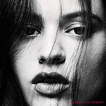 A black and white close-up image of Rosalía, with her name and the album's title in red text on the bottom right.