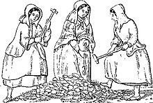 Three women wearing heavy clothing and long bonnets, carrying long hammers, standing around a pile of rocks