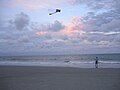 A man flying a kite on the beach of Tybee Island, GA