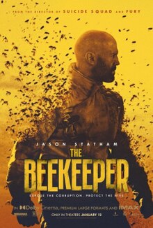 A bald bearded man in a heavy beekeeper jacket surrounded by bees. The image is in only black and yellow.