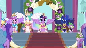 Twilight Sparkle (front) wearing a dress and crown with Applejack, Princess Cadance, Princess Celestia, Princess Luna, and Spike (background, left to right), all of whom are wearing formal clothing