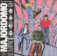 An illustration of the four band members posed in different fashions, all looking at the camera. Behind them is purple framing that one of the members is hanging from their hands on. On the left hand side is a black strip featuring the album title in block letters, the band name and the dictionary definition of a majordomo.