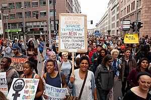 A protester at a Black Lives Matter demonstration in Berlin holds a Generation ADEFRA sign.