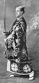 Man in Japanese costume, carrying a large sword