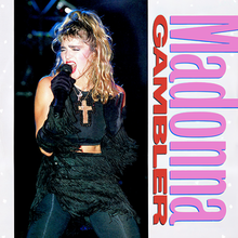 Madonna singing, wearing a crucifix around her neck.