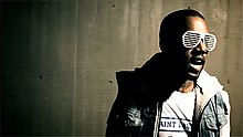 West wearing his trademark shutter shades in the music video