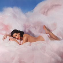 The album cover depicts Katy Perry lying naked on clouds of cotton candy.