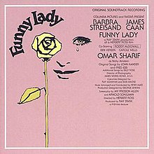 The vinyl sleeve of the album appears displaying a face with a tear drop falling from one eye behind a yellow rose atop a purple background.