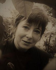 Black and white portrait photograph of Lorna Young in a garden