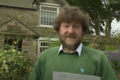 Jim Ridge, in front of his cottage on 3 September 1993, reading the letter he wrote to Time Team. Ridge died on 21 January 2003[6][7]
