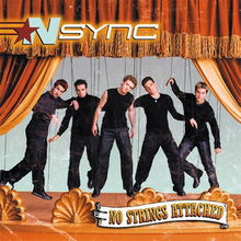 The band members are attached to rope strings posing like puppets, on top of an orange theatrical stage. The album's title is placed on the bottom-right corner.