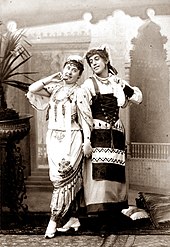photograph of young white woman and a young man in drag