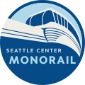 The logo of the Seattle Center Monorail system, which consists of a circular badge with a stylized monorail train