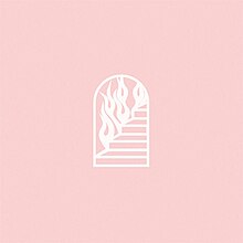 A doorway leading to a stairwell, with a raging fire beside it, on a dark pink background.