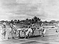 Men of No 5353 Airfield Construction Wing, Royal Air Force (RAF), assist and supervise Japanese prisoners of war during the construction of the main runway at Changi.