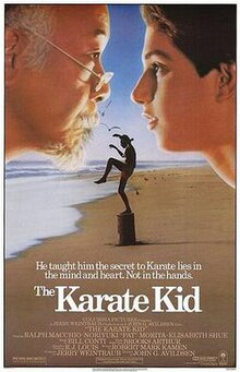 The poster shows an elderly man looking at a teenager. In the background, the teenage stands on stop of a small wooden pole doing a karate stance at a beach. Below, the tagline reads "He taught him the secret to Karate lines in the mind and heart. Not in the hands". The films titles, credits, and rating is printed below the tagline.