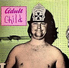 A saturated image of Brian Wilson in a fire hat on with the words "Adult Child" written in a pink box next to him