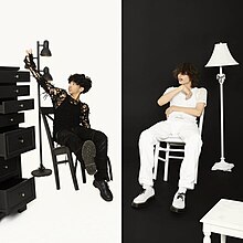 Ericdoa is sitting on the left in black clothing in front of a white background, surrounded by a dresser and a lamp. Glaive is sitting on the right in white clothing in front of a black background, surrounded by a lamp and a chair.