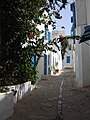 Typical street with white walls and blue window shades