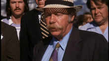 Film still of Charles Willeford, with a large moustache, wearing a straw hat