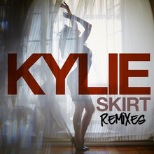 Minogue standing in heels behind a curtain, with the words 'Kylie' and 'Skirt' superimposed in a red font.