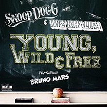 The letters "Snoop Dogg & Wiz Khalifa Young, Wild & Free featuring Bruno Mars" written in capital chalk font on a chalk board.