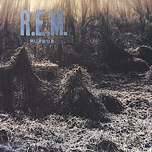 A train trestle covered in thick kudzu with "R.E.M. / MURMUR" written in blue