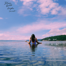 Katherine Paul standing in waist-high water with her back turned to the viewer