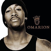 An image of a man wearing a black tank top, toque and diamond earrings. Beside him are both the artist's name and album logo title colored in brown.