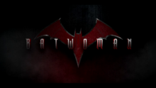 "BATWOMAN" written in a metallic font over a dark background with a red and orange bat symbol in the background.
