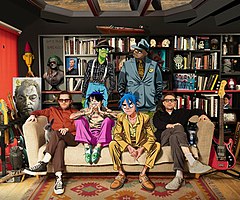 Gorillaz in 2020. Jamie Hewlett (left) and Damon Albarn (right) with animated members Murdoc Niccals (top left), Russel Hobbs (top right), 2-D (bottom right), and Noodle (bottom left).
