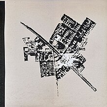 An excerpt of a black-and-white aerial photograph of several buildings surrounding a road labeled "Massachusetts".