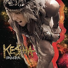 An image of Kesha looking angrily to her right is placed upon a multicolored galaxy background. The word "Kesha" is embossed in a gold glitter font in the bottom left corner. Underneath it is the word "Cannibal", in a smaller white font.