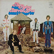 Left to right: Chris Ethridge, "Sneaky" Pete Kleinow, Gram Parsons, and Chris Hillman, wearing Nudie suits in a desert scene