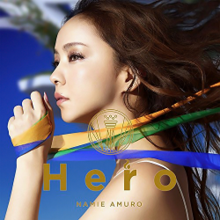 A close-up image of Namie Amuro's face, holding ribbons that resemble the Brazilian flag. A blue wallpaper is present in the background.