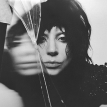 Black-and-white photo of Gaga's face near a piece of glass