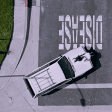 A car parked beneath upside down text reading "Disease"