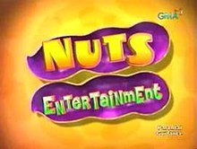 An image of an opened nut, over an orange glossy background. The show title is displayed on the center of the image. The logo of GMA Network is displayed on the upper right side of the image. The text "parental guidance" is shown on the lower right side of the image.