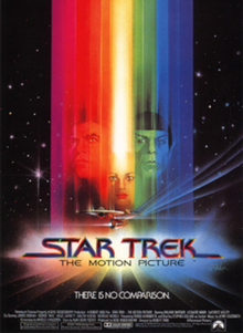 The faces of Kirk, Spock, and Ilia, covered by a spectrum of colored horizontal bars, on a starfield background.