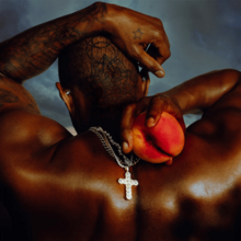 Usher holding a peach behind his neck