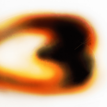 A blurry object in the shape of the number 3.