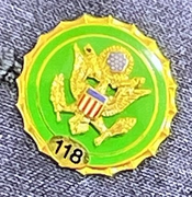A small pin held onto an article of clothing with a Congressional seal on it