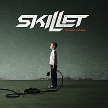 A photo of a boy holding a plug in a tunnel with "Skillet - Comatose" above the boy.