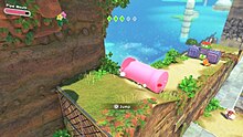 A screenshot of Kirby and the Forgotten Land, where Kirby is rolling down a hill using the Mouthful Mode 'Pipe Mouth'