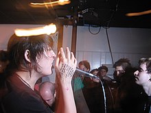 Michelle Proffit (vocals), with setlist written on her hand.