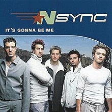 The NSYNC members are wearing white and grey shirts, standing in front of a valley. Above them is the song title and band name, positioned on a dark blue background.