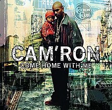 Cam'ron stands wearing a black leather coat and large chain while holding his toddler son wearing a red shirt, red hat, and a chain as well. The background is a collage of various images of New York City, such as the famous Cotton Club.