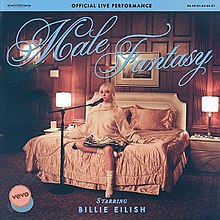 Cover art for the official live performance of "Male Fantasy": Billie Eilish on a hotel room bed, with a microphone stand next to her. Above her is the song title, written in blue and in a cursive font.