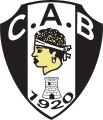 Blason noir et blanc avec une tête de Maure, symbole de la Corse. En dessous figurent une tour et la date 1920.