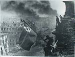 התמונה המעובדת של הנפת הדגל. השעון הימני רוטש, והעשן המיתמר מעל ברלין עובה